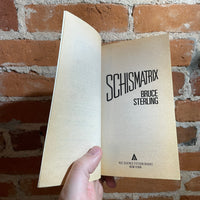 Schismatrix - Bruce Sterling - 1986 Ace Books Paperback - John Harris Cover